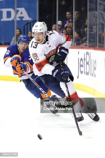 Mark Pysyk of the Florida Panthers skates with the puck against Anthony Beauvillier of the New York Islanders in the second period during their game...