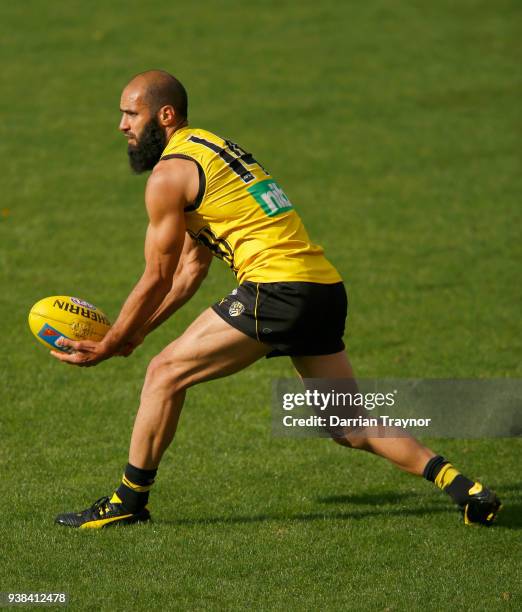 Bachar Houli handballs during a Richmond Tigers AFL training session at Punt Road Oval on March 27, 2018 in Melbourne, Australia.