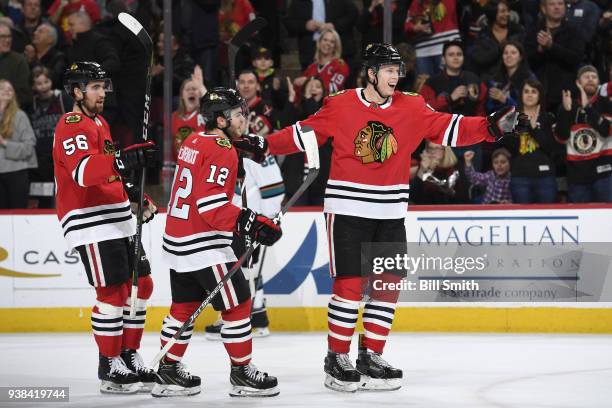 Erik Gustafsson, Alex DeBrincat and Connor Murphy of the Chicago Blackhawks celebrate after Murphy scored against the San Jose Sharks in the first...