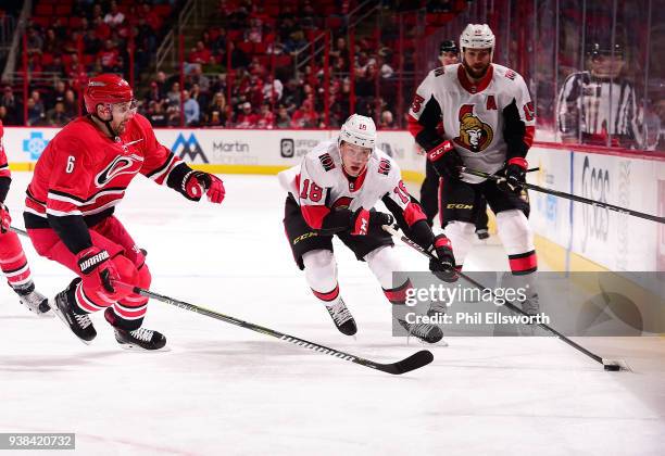 Klas Dahlbeck of the Carolina Hurricanes defends Ryan Dzingel of the Ottawa Senators during an NHL game on March 26, 2016 at PNC Arena in Raleigh,...