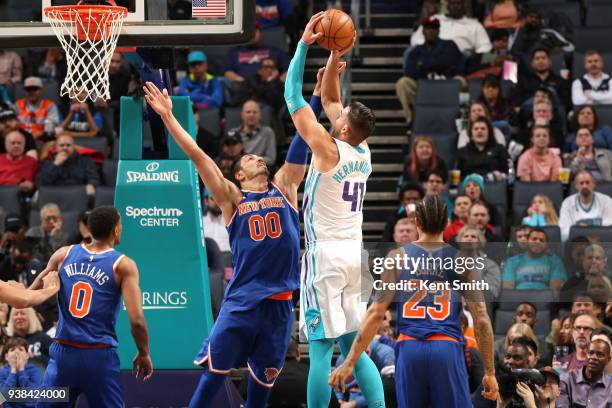 Enes Kanter of the New York Knicks blocks the shot against Willy Hernangomez of the Charlotte Hornets on March 26, 2018 at Spectrum Center in...