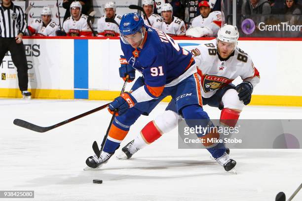 John Tavares of the New York Islanders controls the puck amid pressure from Jamie McGinn of the Florida Panthers during the third period at Barclays...