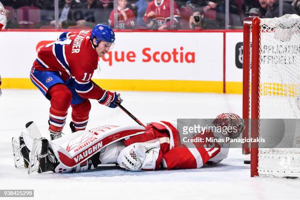 Brendan Gallagher of the Montreal Canadiens skates in as the puck approaches the goal line while goaltender Jared Coreau of the Detroit Red Wings...