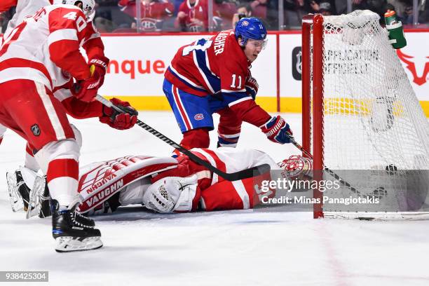 Brendan Gallagher of the Montreal Canadiens tips in the puck past goaltender Jared Coreau of the Detroit Red Wings during the NHL game at the Bell...