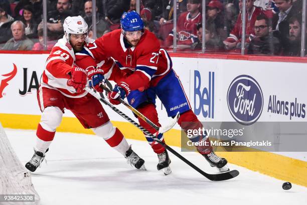 Henrik Zetterberg of the Detroit Red Wings and Alex Galchenyuk of the Montreal Canadiens skate after the puck during the NHL game at the Bell Centre...