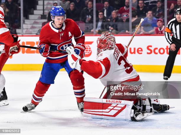 Goaltender Jared Coreau of the Detroit Red Wings makes a glove save near Brendan Gallagher of the Montreal Canadiens during the NHL game at the Bell...