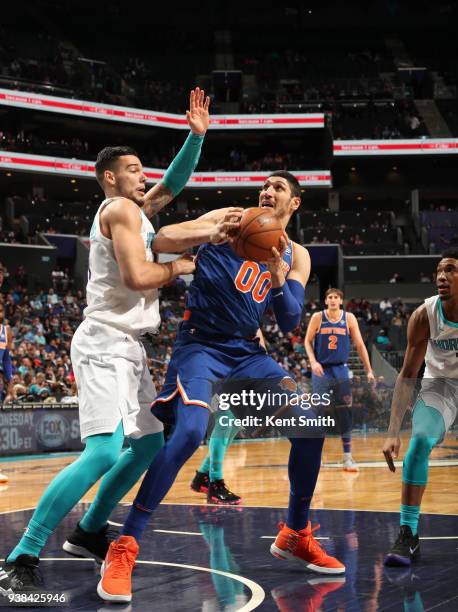 Enes Kanter of the New York Knicks handles the ball against Willy Hernangomez of the Charlotte Hornets on March 26, 2018 at Spectrum Center in...