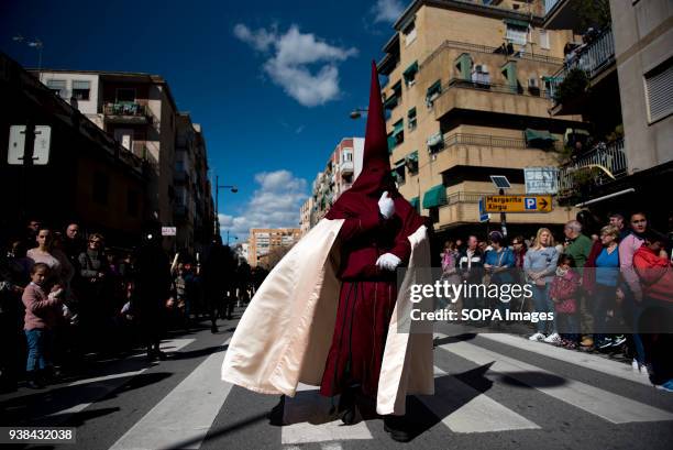 Penitent from the "Trabajo y Luz" brotherhood during the Holy Monday procession in Granada. Every year thousands of christians believers celebrates...