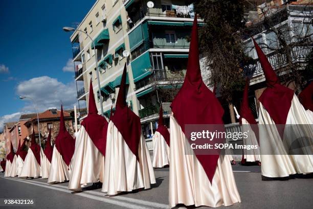 Penitents from the "Trabajo y Luz" brotherhood march in procession during the Holy Monday in Granada. Every year thousands of christians believers...