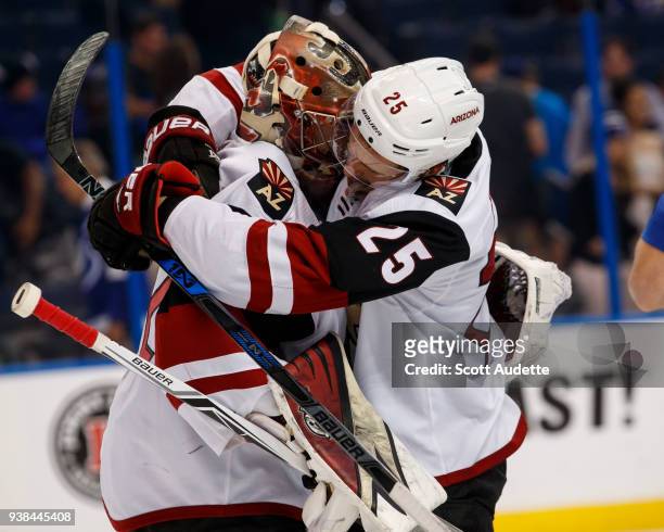 Goalie Antti Raanta and Nick Cousins of the Arizona Coyotes celebrate the win against the Tampa Bay Lightning at Amalie Arena on March 26, 2018 in...