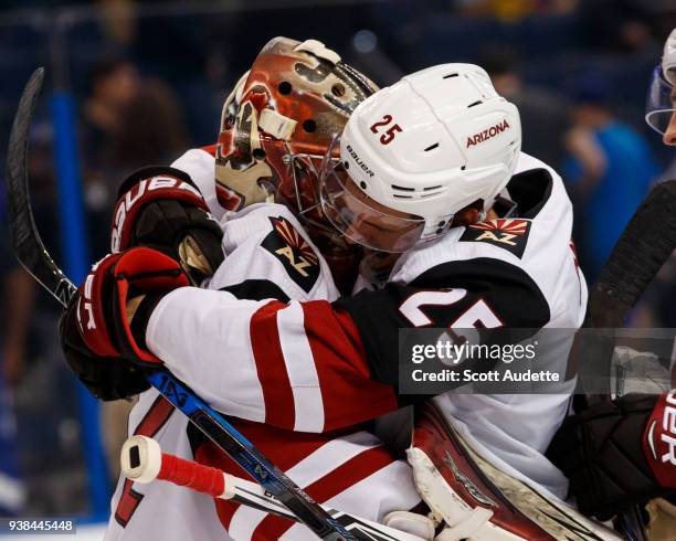 Goalie Antti Raanta and Nick Cousins of the Arizona Coyotes celebrate the win against the Tampa Bay Lightning at Amalie Arena on March 26, 2018 in...