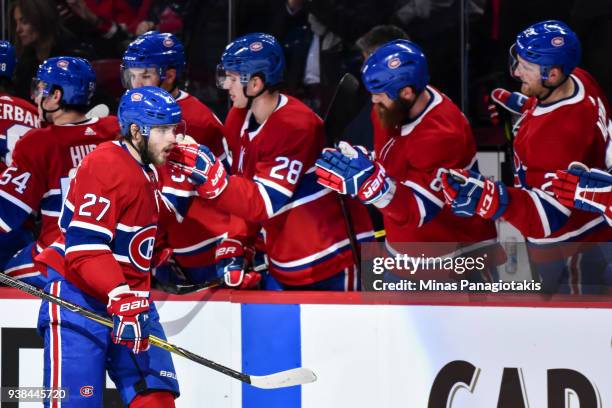 Alex Galchenyuk of the Montreal Canadiens celebrates his third period goal with teammates on the bench against the Detroit Red Wings during the NHL...