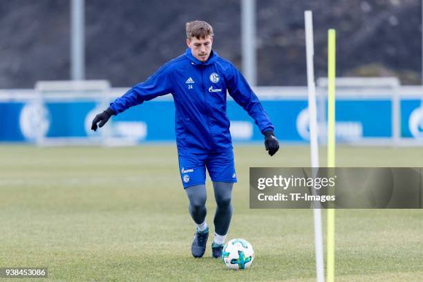 Bastian Oczipka of Schalke controls the ball during a training session at the FC Schalke 04 Training center on March 23, 2018 in Gelsenkirchen,...