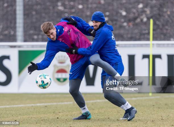 Bastian Oczipka of Schalke and Daniel Caligiuri of Schalke battle for the ball during a training session at the FC Schalke 04 Training center on...
