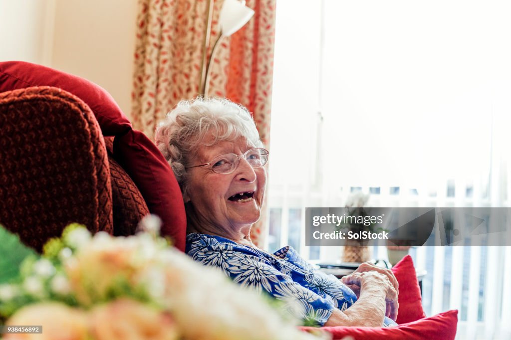 Senior Woman Sitting Laughing