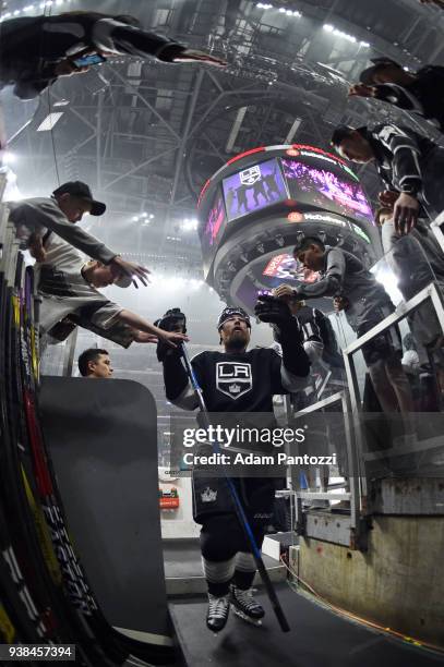 Jake Muzzin of the Los Angeles Kings high-fives fans before a game against the Calgary Flames at STAPLES Center on March 26, 2018 in Los Angeles,...