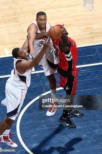 Jason Collins and Randolph Morris of the Atlanta Hawks go for the rebound against Pops Mensah-Bonsu of the Toronto Raptors during the game on...