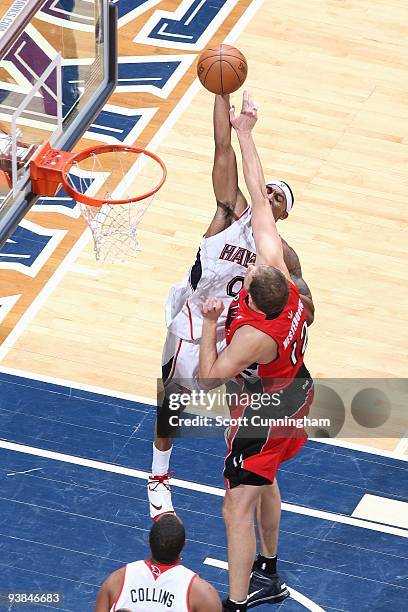 Jeff Teague of the Atlanta Hawks goes to the basket under pressure against Rasho Nesterovic of the Toronto Raptors during the game on December 2,...