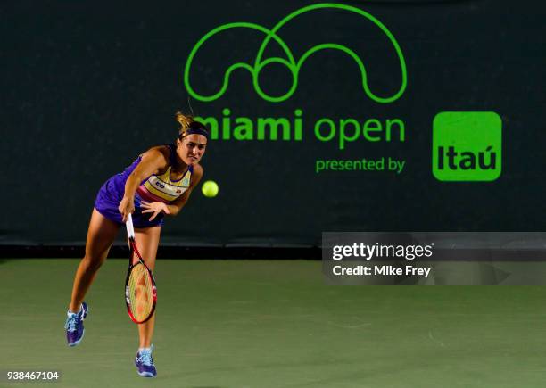 Monica Puig of Puerto Rico serves to Danielle Collins of the USA on Day 8 of the Miami Open Presented by Itau at Crandon Park Tennis Center on March...