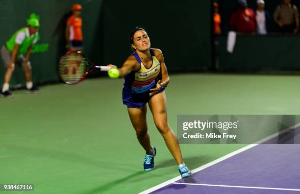 Monica Puig of Puerto Rico hits a forehand to Danielle Collins of the USA on Day 8 of the Miami Open Presented by Itau at Crandon Park Tennis Center...