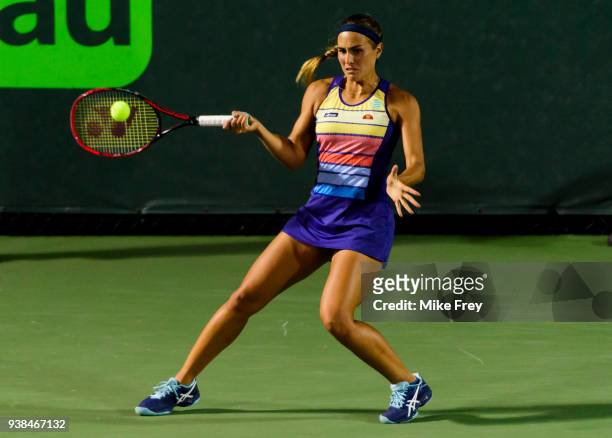 Monica Puig of Puerto Rico hits a forehand to Danielle Collins of the USA on Day 8 of the Miami Open Presented by Itau at Crandon Park Tennis Center...