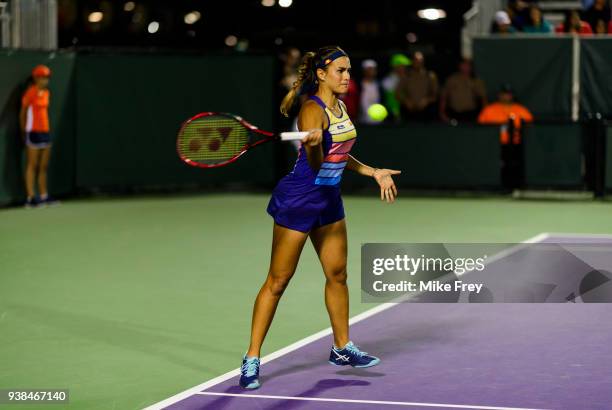 Monica Puig of Puerto Rico hits a forehand to Danielle Collins of the USA on Day 8 of the Miami Open Presented by Itau at Crandon Park Tennis Center...