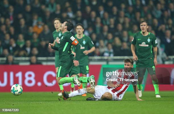 Zlatko Junuzovic of Werder Bremen and Salih Oezcan of Koeln battle for the ball during the Bundesliga match between SV Werder Bremen and 1. FC Koeln...