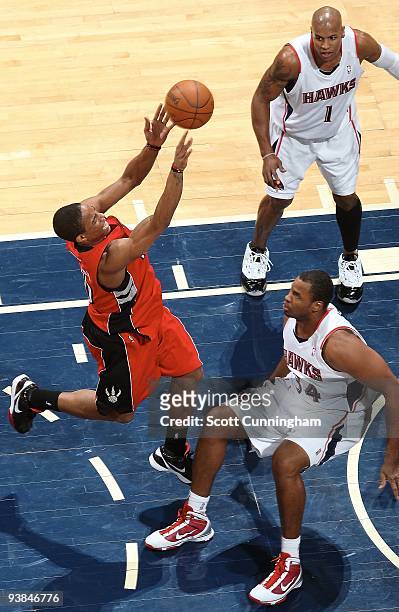 DeMar DeRozan of the Toronto Raptors shoots against Jason Collins and Maurice Evans of the Atlanta Hawks during the game on December 2, 2009 at...