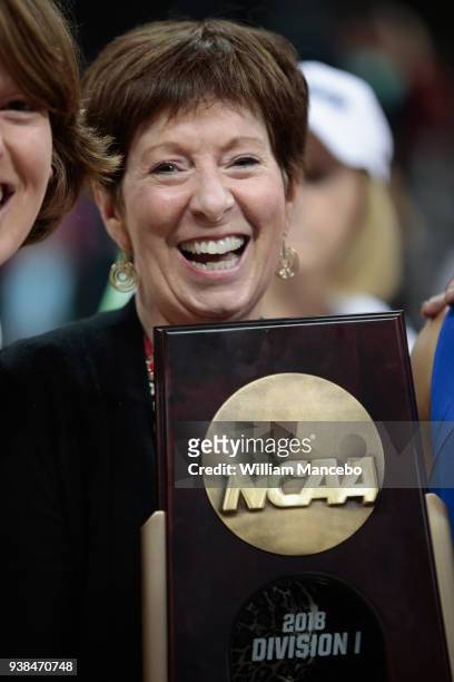 Head coach Muffet McGraw of the The Notre Dame Fighting Irish celebrates with the trophy after defeating the Oregon Ducks 84-74 in the 2018 NCAA...