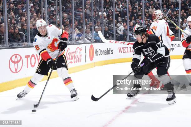 Michael Stone of the Calgary Flames passes the puck against Tyler Toffoli of the Los Angeles Kings at STAPLES Center on March 26, 2018 in Los...