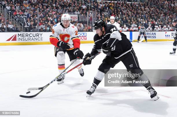 Torrey Mitchell of the Los Angeles Kings battles for the puck against Michael Stone of the Calgary Flames at STAPLES Center on March 26, 2018 in Los...