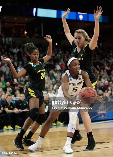 Jackie Young of the Notre Dame Fighting Irish passes the ball against Ruthy Hebard and Lydia Giomi of the Oregon Ducks during the 2018 NCAA Division...