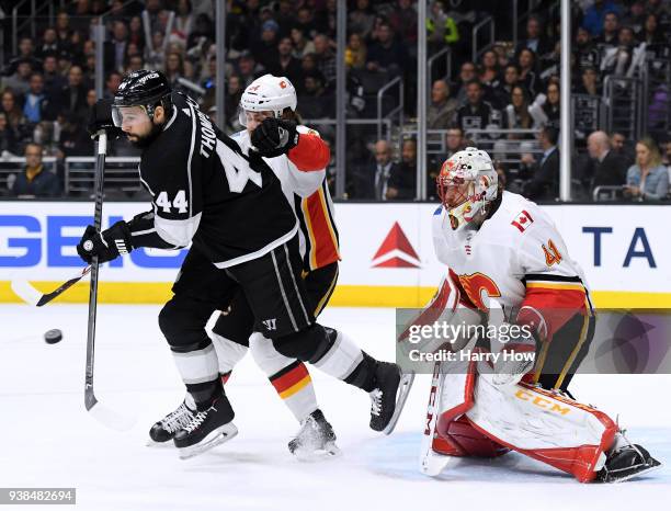 Nate Thompson of the Los Angeles Kings deflects a shot in front of Mike Smith and Rasmus Andersson of the Calgary Flames during the second period at...