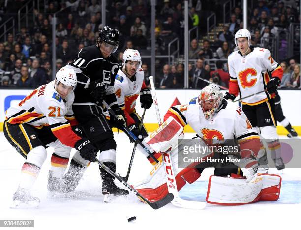 Mike Smith of the Calgary Flames makes a save in front of Anze Kopitar of the Los Angeles Kings and Garnet Hathaway during the second period at...
