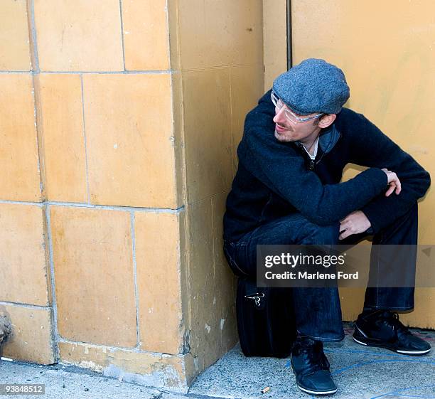 man sitting on computer case in a doorway - computer tower stock pictures, royalty-free photos & images