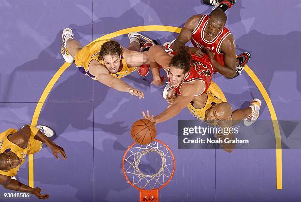Joakim Noah of the Chicago Bulls shoots a layup against Pau Gasol and Derek Fisher of the Los Angeles Lakers during the game at Staples Center on...