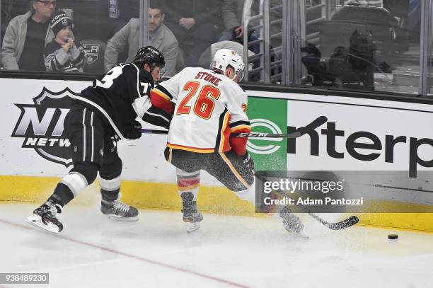 Tyler Toffoli of the Los Angeles Kings battles for the puck against Michael Stone of the Calgary Flames at STAPLES Center on March 26, 2018 in Los...