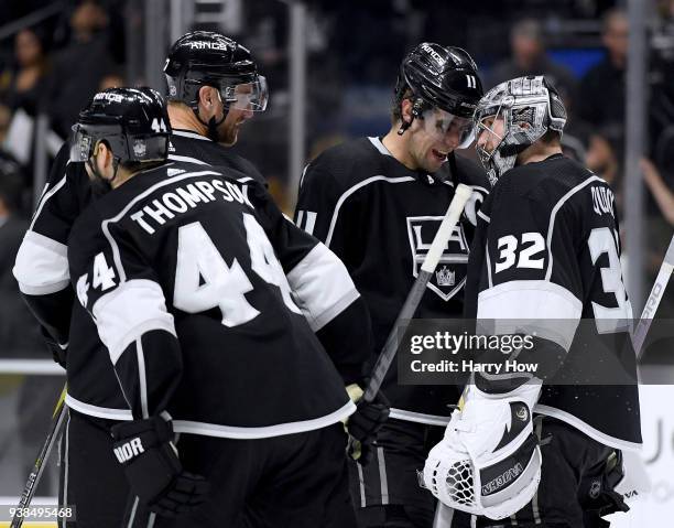 Jonathan Quick of the Los Angeles Kings celebrates a 3-0 win over the Calgary Flames with Anze Kopitar, Jeff Carter and Nate Thompson at Staples...