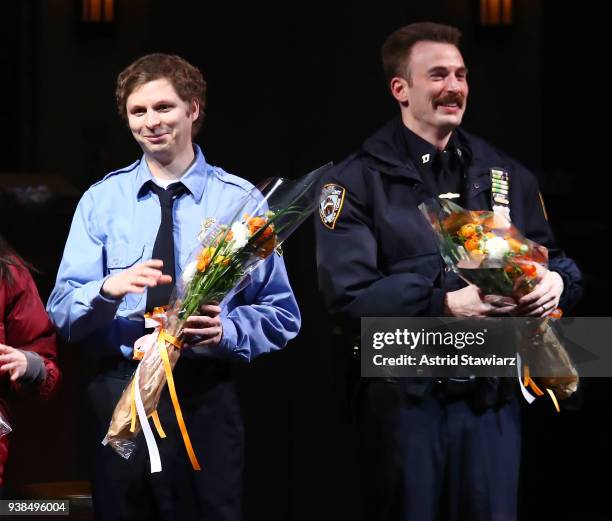 Actors Michael Cera and Chris Evans pose for photos during curtain call "Lobby Hero" Broadway opening night party for Bryant Park Grill on March 26,...