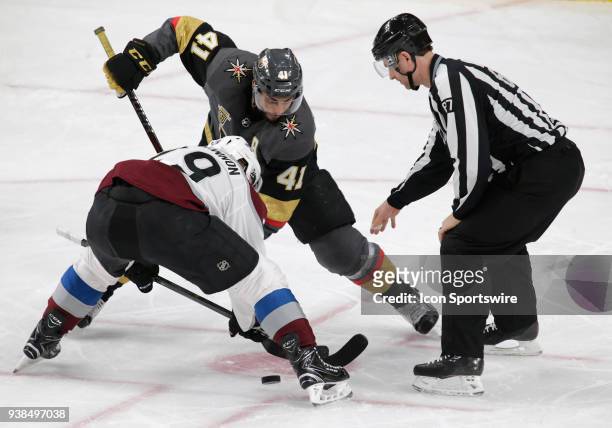 Vegas Golden Knights left wing Pierre-Edouard Bellemare and Colorado Avalanche center Nathan MacKinnon face off during the second period of a regular...