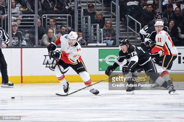 Michael Frolik of the Calgary Flames skates after the puck against Tyler Toffoli of the Los Angeles Kings at STAPLES Center on March 26, 2018 in Los...