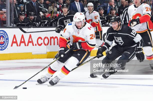 Travis Hamonic of the Calgary Flames handles the puck against Alex Iafallo of the Los Angeles Kings at STAPLES Center on March 26, 2018 in Los...