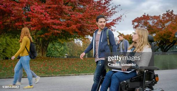 students at university campus - blonde woman wheelchair stock pictures, royalty-free photos & images