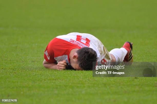 Rani Khedira of Augsburg lays injured on the ground during the Bundesliga match between FC Augsburg and SV Werder Bremen at WWK-Arena on March 17,...