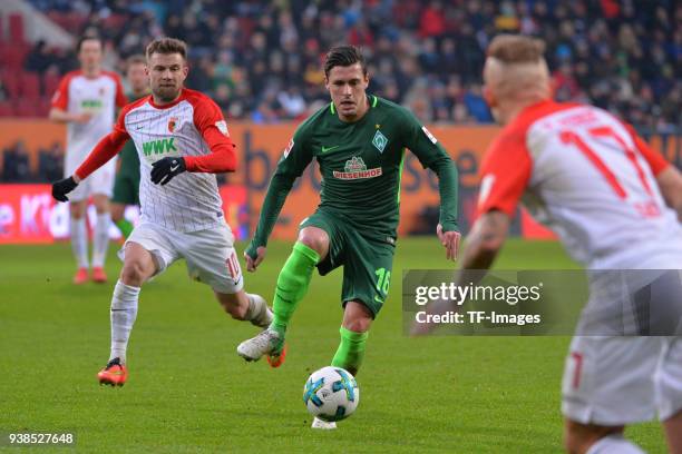 Daniel Baier of Augsburg and Zlatko Junuzovic of Bremen battle for the ball during the Bundesliga match between FC Augsburg and SV Werder Bremen at...