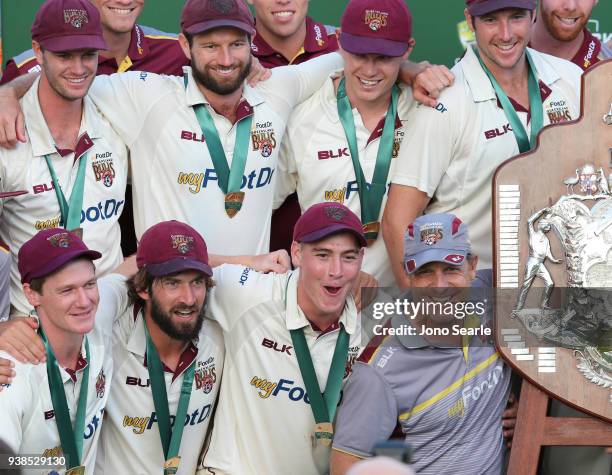 The Queensland team including coach Wade Seccombe celebrate winning the final during day five of the Sheffield Shield final match between Queensland...