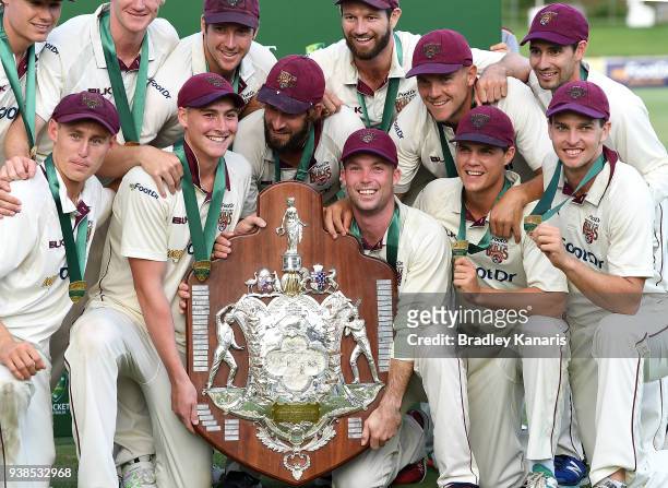 Queensland players celebrate victory after winning the Sheffield Shield final during day five of the Sheffield Shield final match between Queensland...