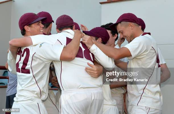 Queensland players celebrate victory after winning the Sheffield Shield final during day five of the Sheffield Shield final match between Queensland...