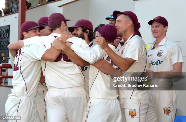 Queensland players celebrate victory after winning the Sheffield Shield final during day five of the Sheffield Shield final match between Queensland...
