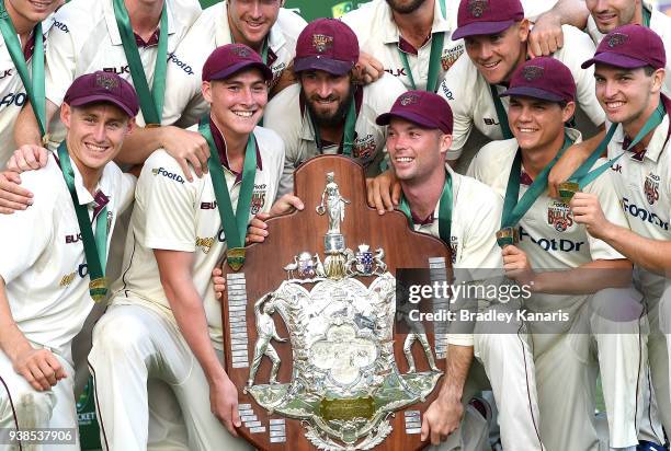 Queensland players celebrate victory after winning the Sheffield Shield during day five of the Sheffield Shield final match between Queensland and...